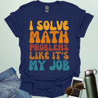 A t-shirt with the text 'I SOLVE MATH PROBLEMS LIKE IT'S MY JOB' printed in a retro, colorful, and bold font.