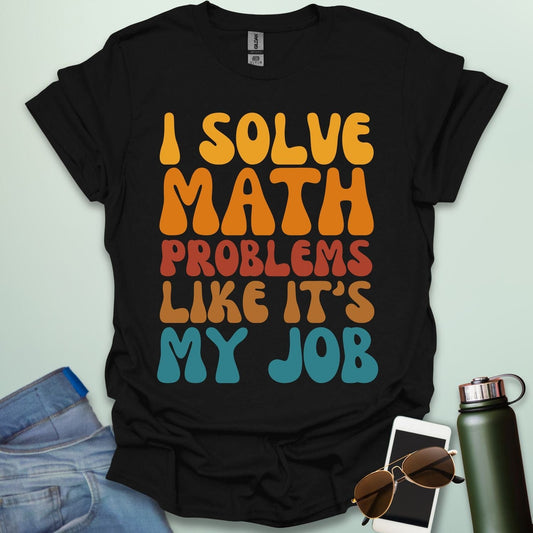 A t-shirt with the text 'I SOLVE MATH PROBLEMS LIKE IT'S MY JOB' printed in a retro, colorful, and bold font.