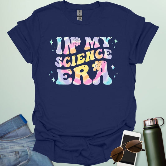 A navy blue t-shirt with wavy, tie-dye text that says 'IN MY SCIENCE ERA' with flowers and stars.