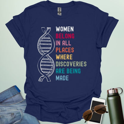 A navy blue t-shirt with the text 'WOMEN BELONG IN ALL PLACES WHERE DISCOVERIES ARE BEING MADE' in a typewriter-style font.