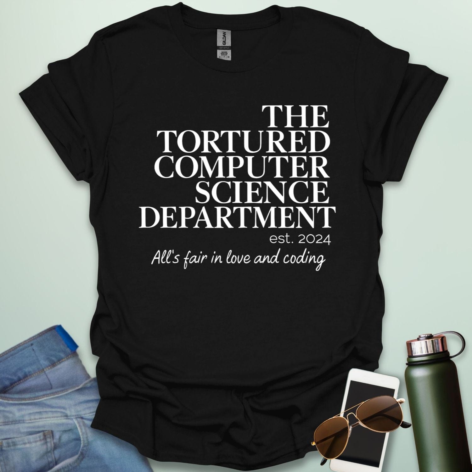 A black t-shirt with the text 'THE TORTURED COMPUTER SCIENCE DEPARTMENT est. 2024' and 'All's fair in love and coding.'