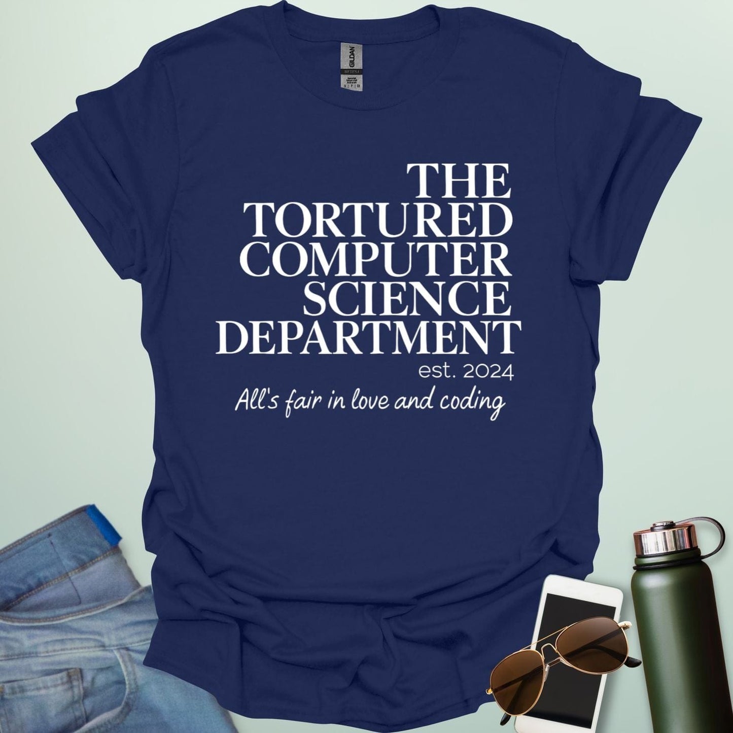 A navy blue t-shirt with the text 'THE TORTURED COMPUTER SCIENCE DEPARTMENT est. 2024' and 'All's fair in love and coding.'