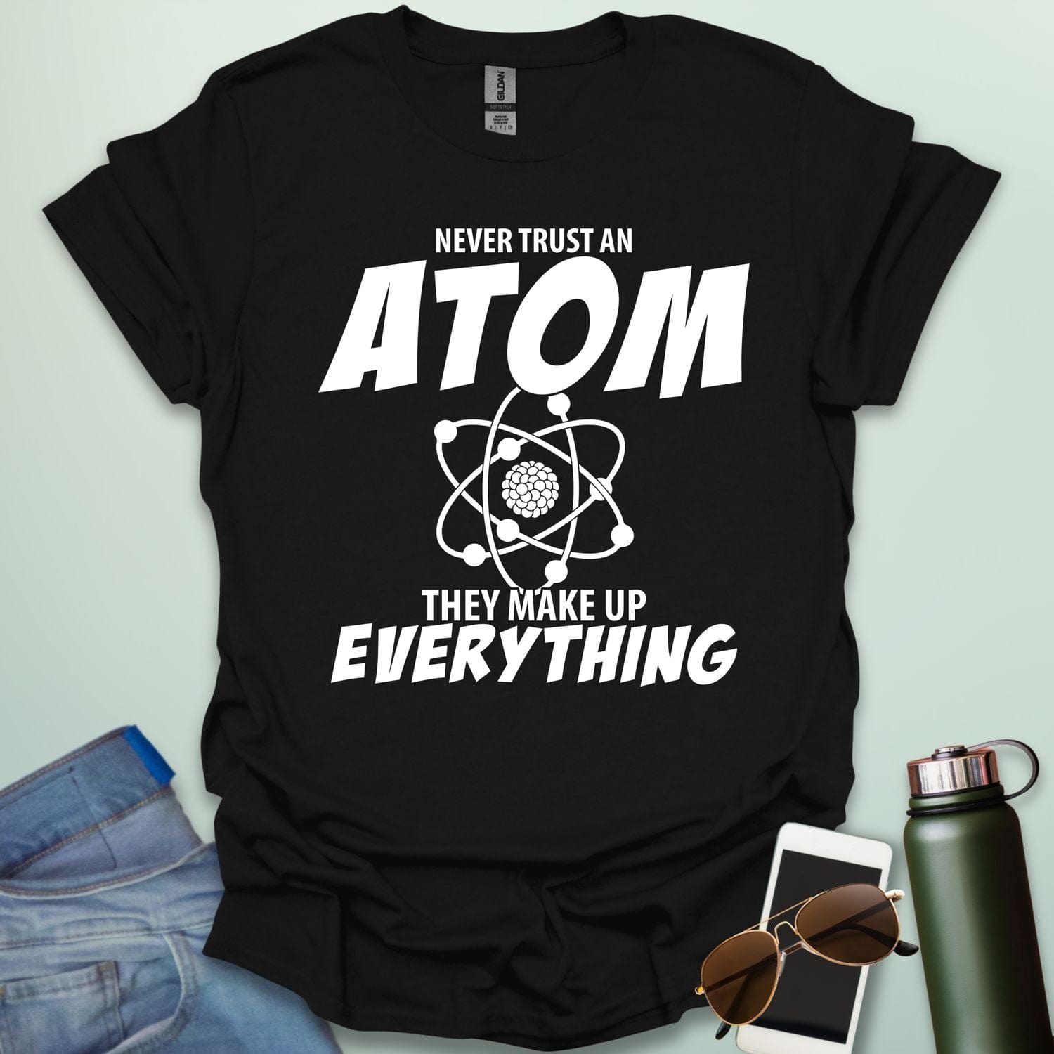 'Never Trust an Atom, They Make Up Everything' funny science t-shirt with atom graphic.