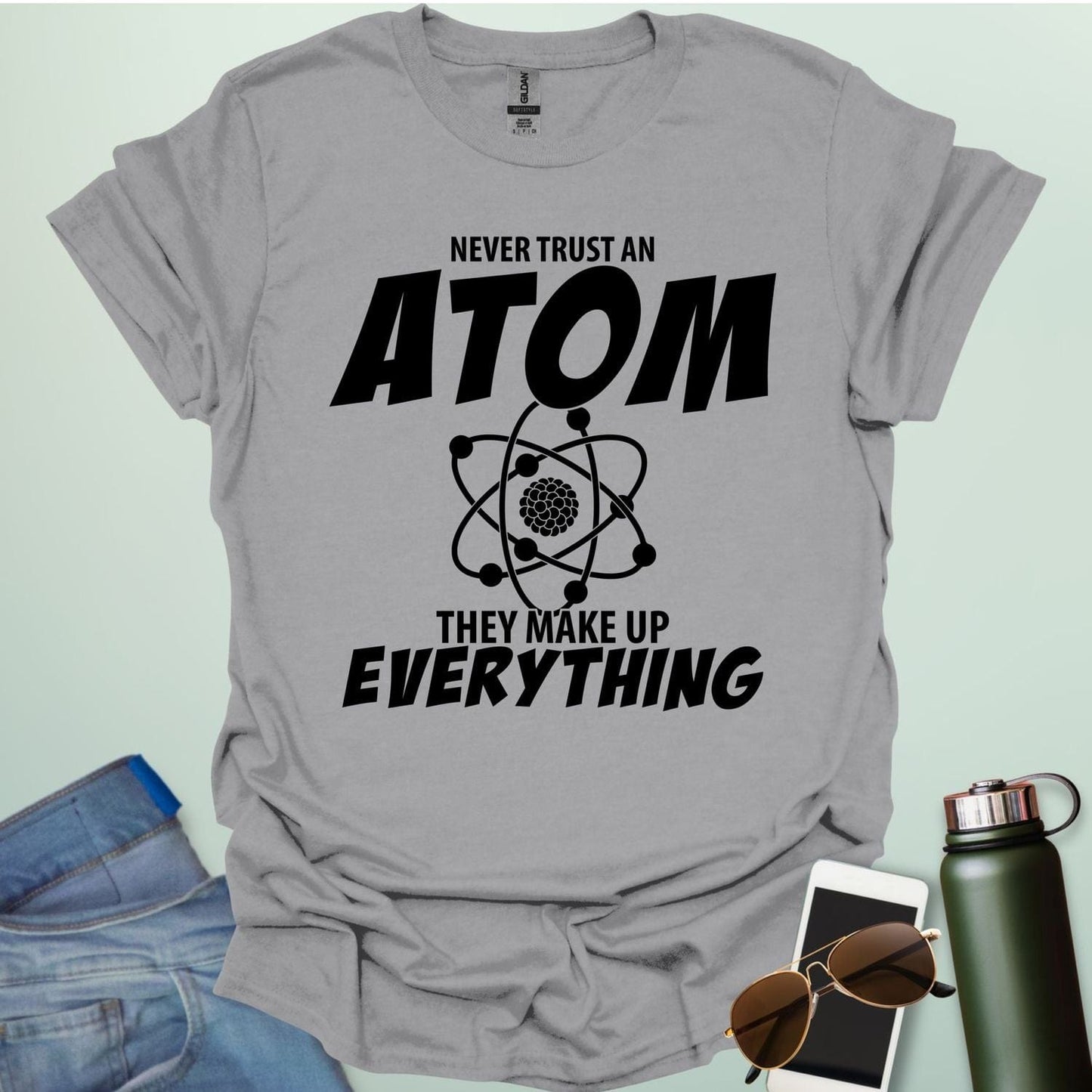 'Never Trust an Atom, They Make Up Everything' funny science t-shirt with atom graphic.