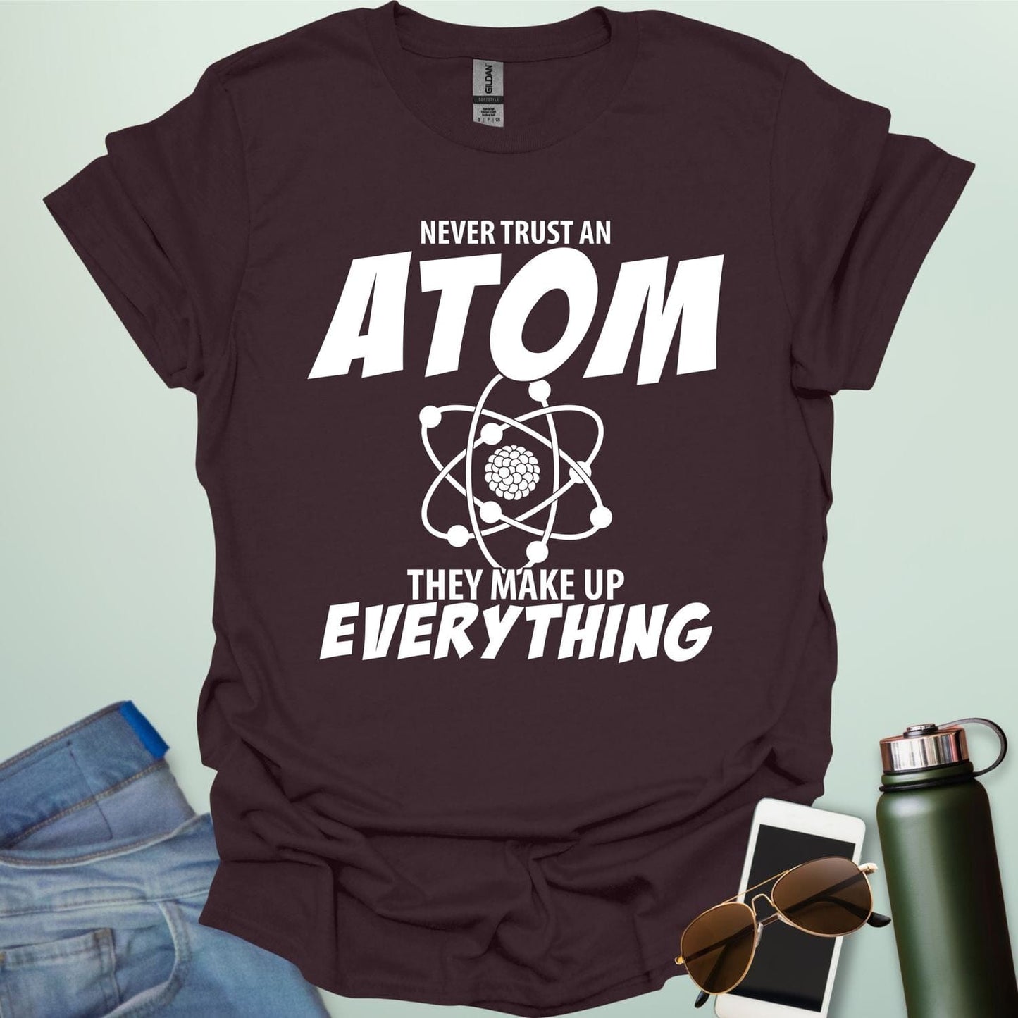 'Never Trust an Atom, They Make Up Everything' funny science t-shirt with atom graphic.