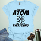 'Never Trust an Atom, They Make Up Everything' funny science t-shirt with atom graphic.