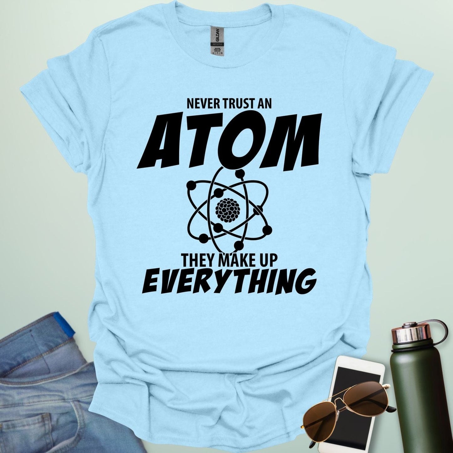 'Never Trust an Atom, They Make Up Everything' funny science t-shirt with atom graphic.