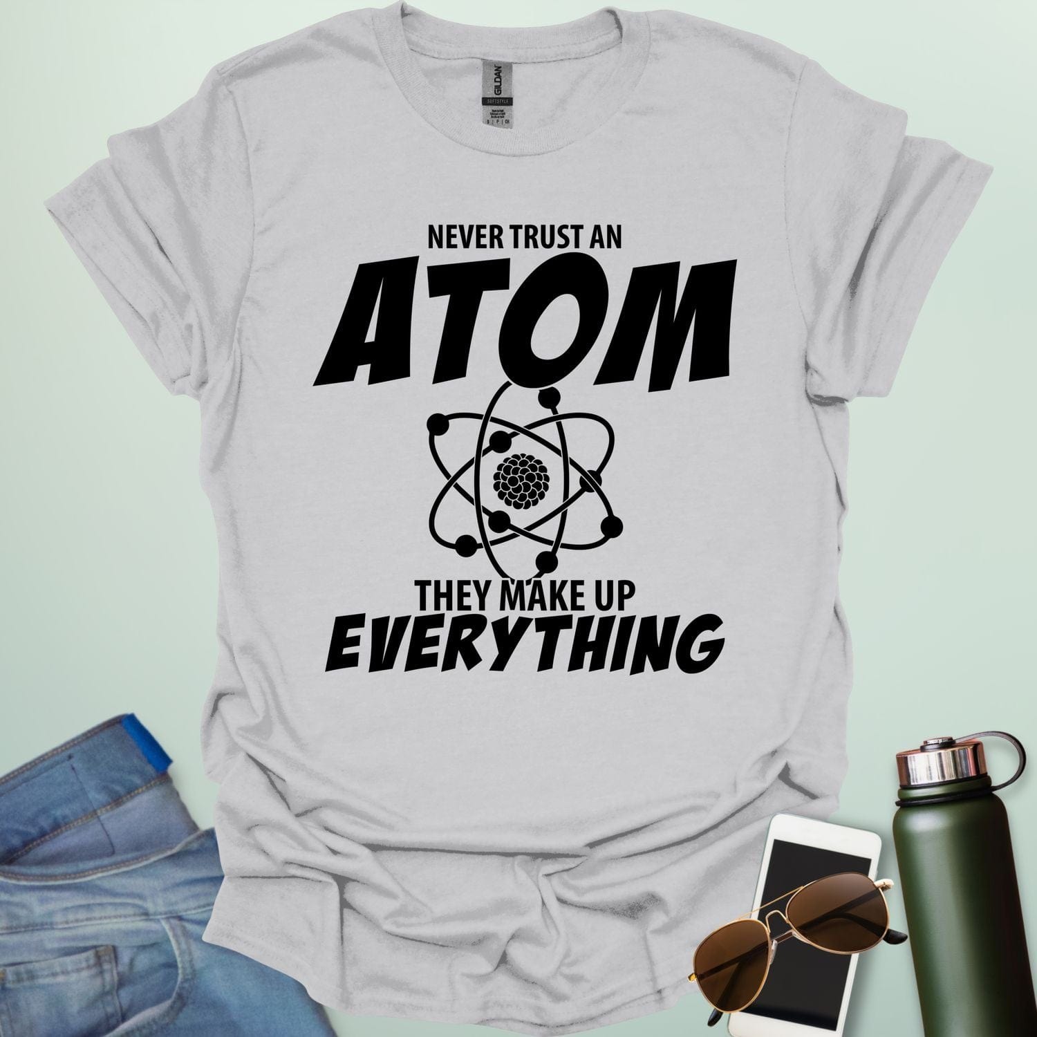 'Never Trust an Atom, They Make Up Everything' funny science t-shirt with atom graphic.