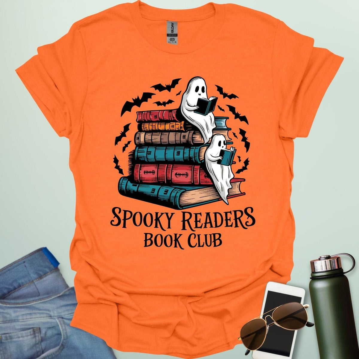 Spooky Readers Book Club t-shirt featuring ghosts reading books — a cozy Halloween design for book lovers and readers.