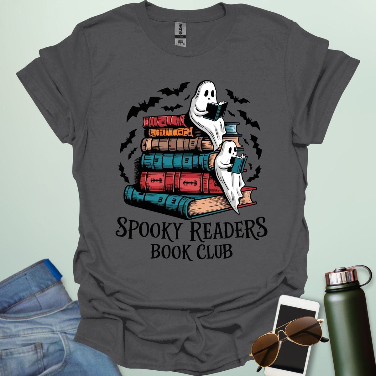 Spooky Readers Book Club t-shirt featuring ghosts reading books — a cozy Halloween design for book lovers and readers.
