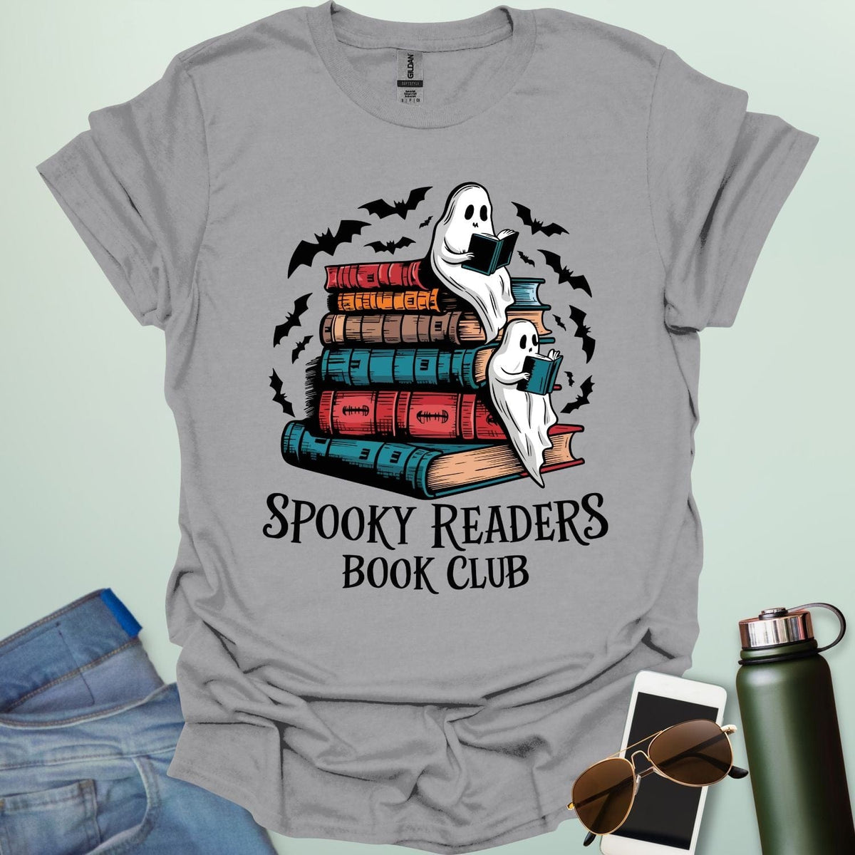 Spooky Readers Book Club t-shirt featuring ghosts reading books — a cozy Halloween design for book lovers and readers.