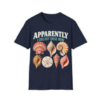 Vintage-style graphic featuring curved retro typography reading 'APPARENTLY I COLLECT THESE NOW' above detailed illustrations of colorful seashells, a nautilus shell, and a sand dollar.