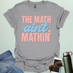 The Math Ain't Mathin'' t-shirt with stylized pink and blue lettering on a solid background.