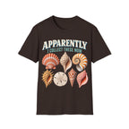 Vintage-style graphic featuring curved retro typography reading 'APPARENTLY I COLLECT THESE NOW' above detailed illustrations of colorful seashells, a nautilus shell, and a sand dollar.
