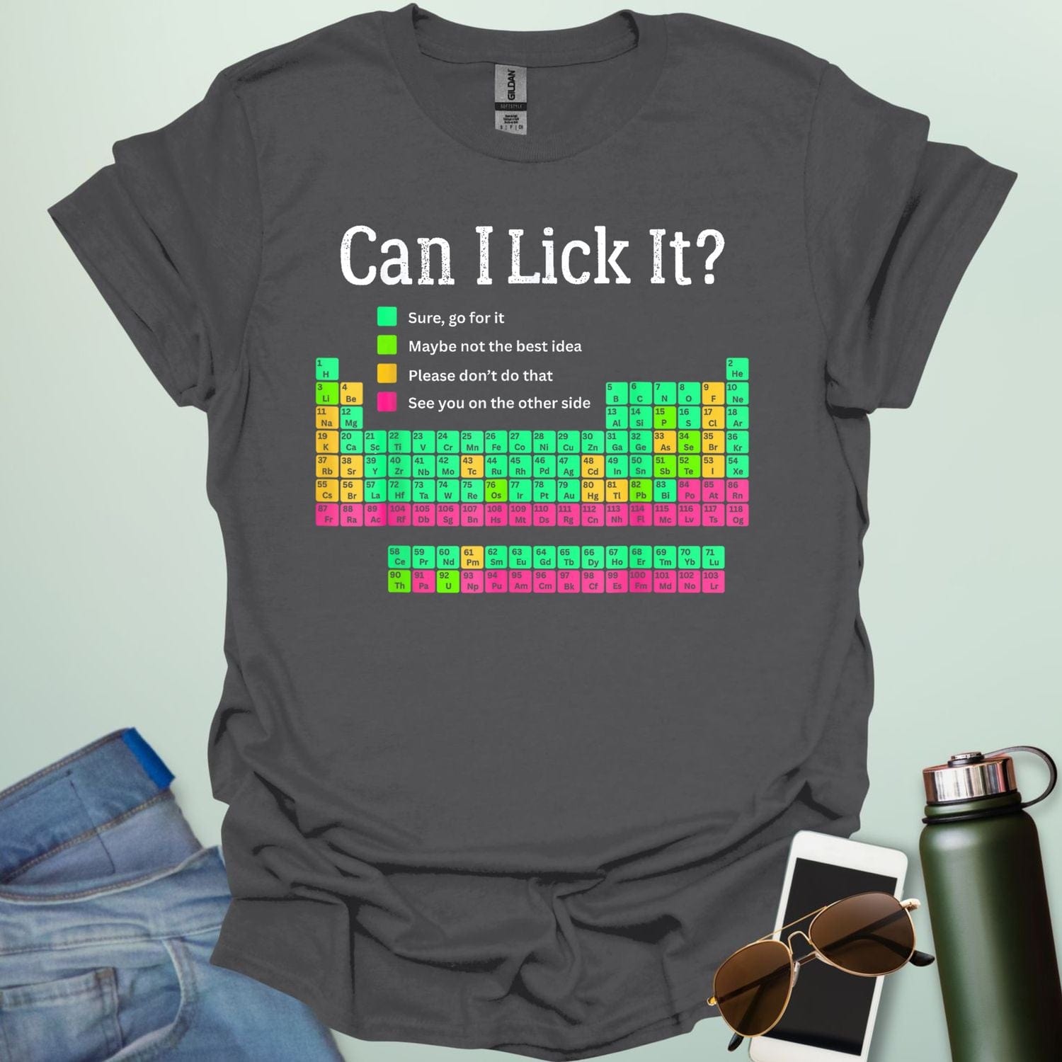 Can I Lick It?' periodic table t-shirt with a color-coded chart of elements and a funny chemistry warning.