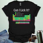 Can I Lick It?' periodic table t-shirt with a color-coded chart of elements and a funny chemistry warning.
