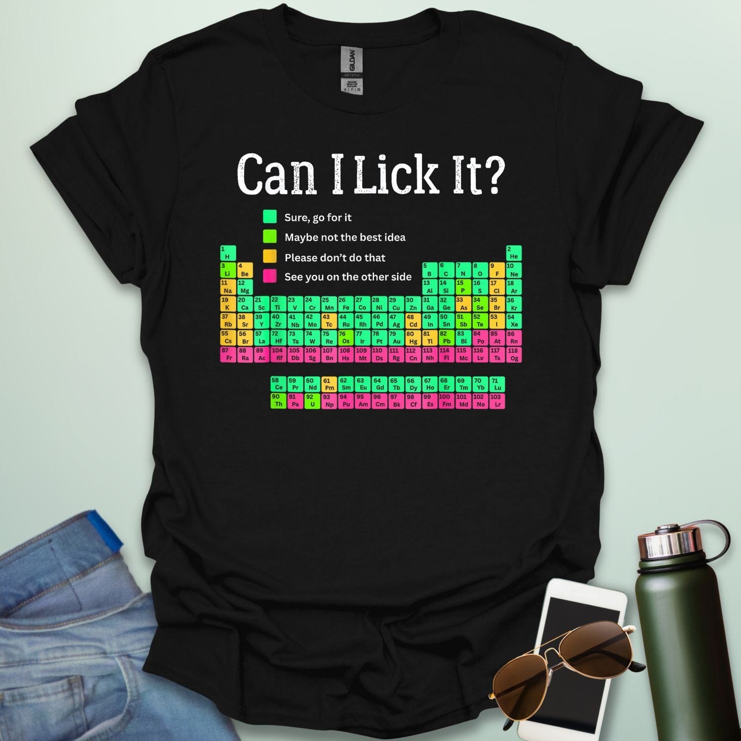 Can I Lick It?' periodic table t-shirt with a color-coded chart of elements and a funny chemistry warning.
