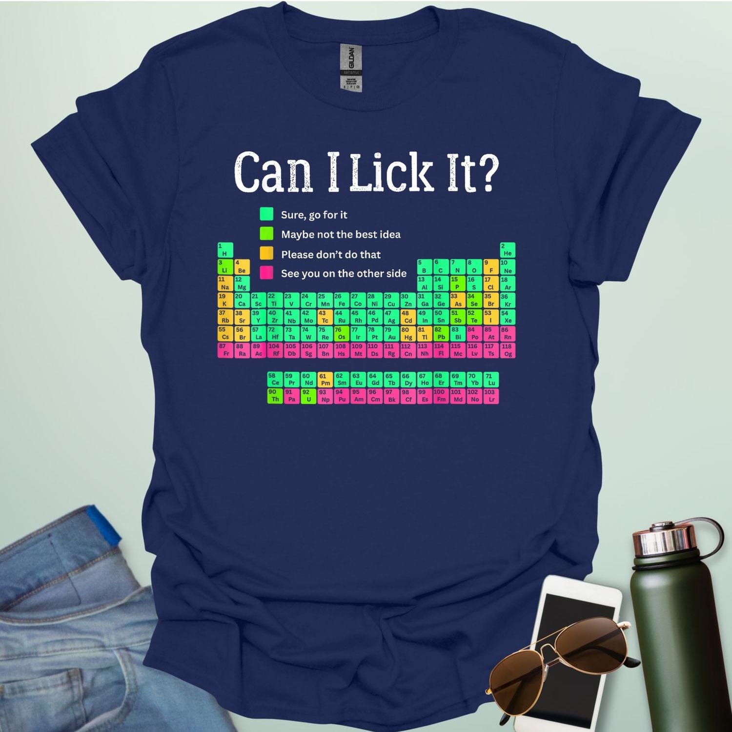 Can I Lick It?' periodic table t-shirt with a color-coded chart of elements and a funny chemistry warning.