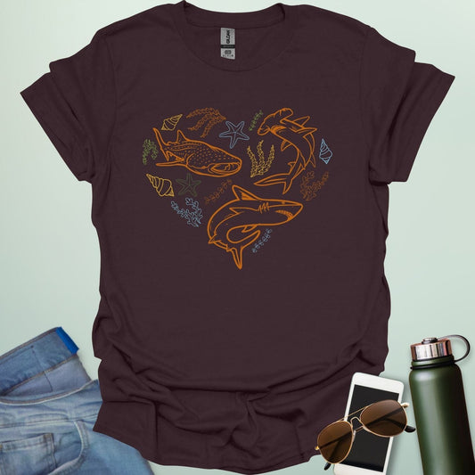 A collection of ocean animals, including sharks, sea stars, and seashells, arranged in a heart shape.