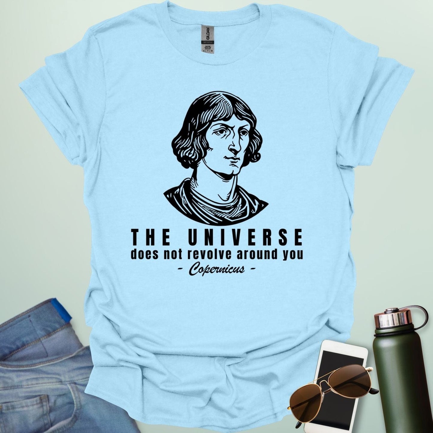 A light blue shirt with a sketch of Copernicus with the text 'The Universe Does Not Revolve Around You' in a bold font.