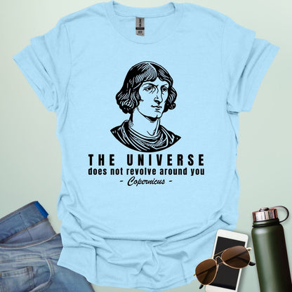 A light blue shirt with a sketch of Copernicus with the text 'The Universe Does Not Revolve Around You' in a bold font.
