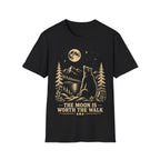 Vintage linocut-style illustration of a bear sitting beside a backpack, gazing up at a full moon over mountains and pine trees with text reading 'THE MOON IS WORTH THE WALK'.