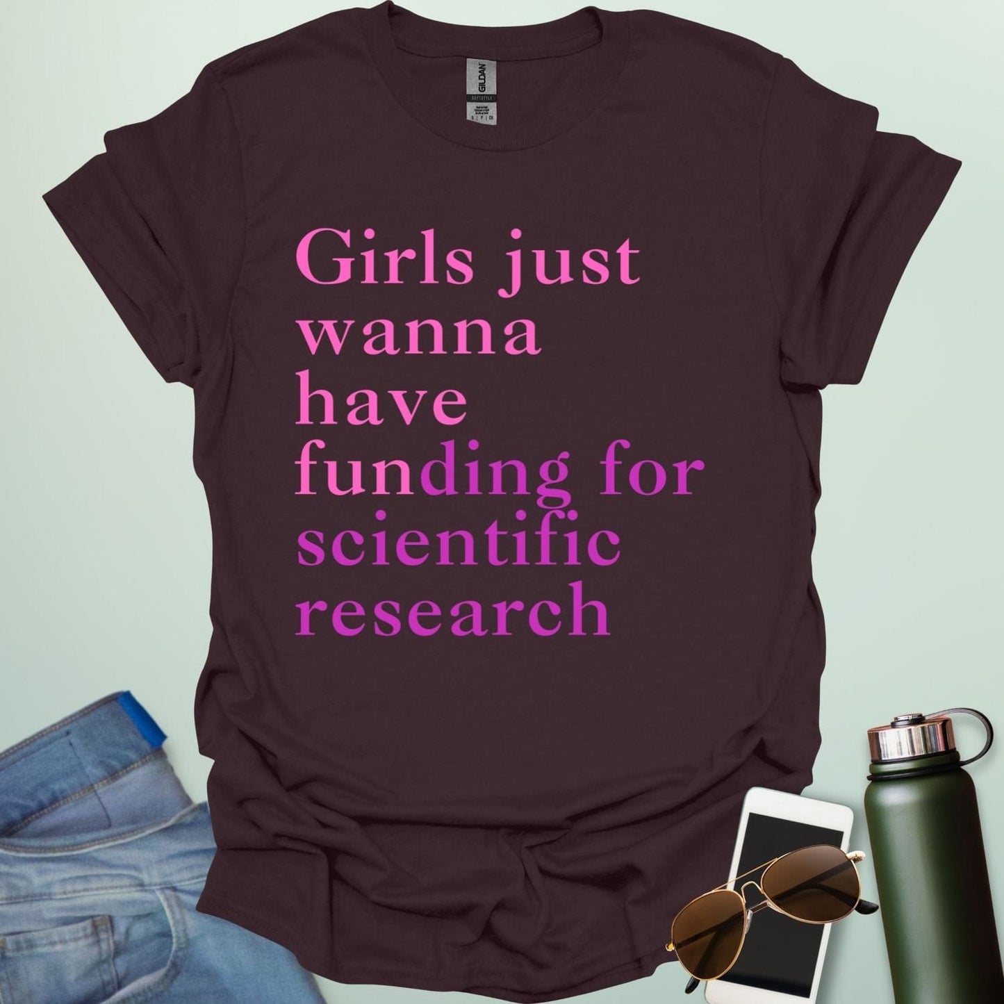A dark chocolate t-shirt with the text 'Girls just wanna have funding for scientific research' in a pink serif font.