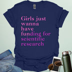 A navy blue t-shirt with the text 'Girls just wanna have funding for scientific research' in a pink serif font.