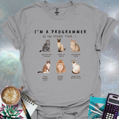 T-shirt design featuring six cat illustrations with the text 'I'm a Programmer - In My Spare Time, I...' and various cat-related activities.
