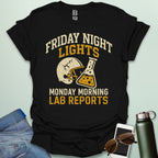 A black t-shirt with a vintage football helmet and a cracked lab flask, with the text 'FRIDAY NIGHT LIGHTS' and 'MONDAY MORNING LAB REPORTS.'