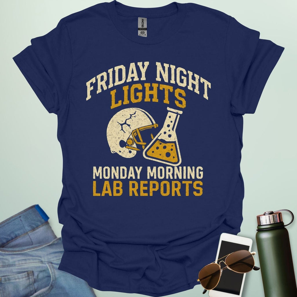 A navy blue t-shirt with a vintage football helmet and a cracked lab flask, with the text 'FRIDAY NIGHT LIGHTS' and 'MONDAY MORNING LAB REPORTS.'