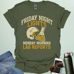A military green t-shirt with a vintage football helmet and a cracked lab flask, with the text 'FRIDAY NIGHT LIGHTS' and 'MONDAY MORNING LAB REPORTS.'A t-shirt with a vintage football helmet and a cracked lab flask, with the text 'FRIDAY NIGHT LIGHTS' and 'MONDAY MORNING LAB REPORTS.'