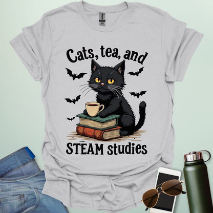 Cats, Tea, and STEAM Studies t-shirt with black cat, books, tea cup, and bats — a cozy geeky design for STEM/STEAM fans and book lovers.