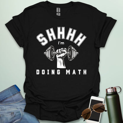 Shhhh… I’m Doing Math t-shirt featuring a retro-style weight plate graphic (45, 15, 20) with distressed text—funny gym-math mashup for fitness and math fans.