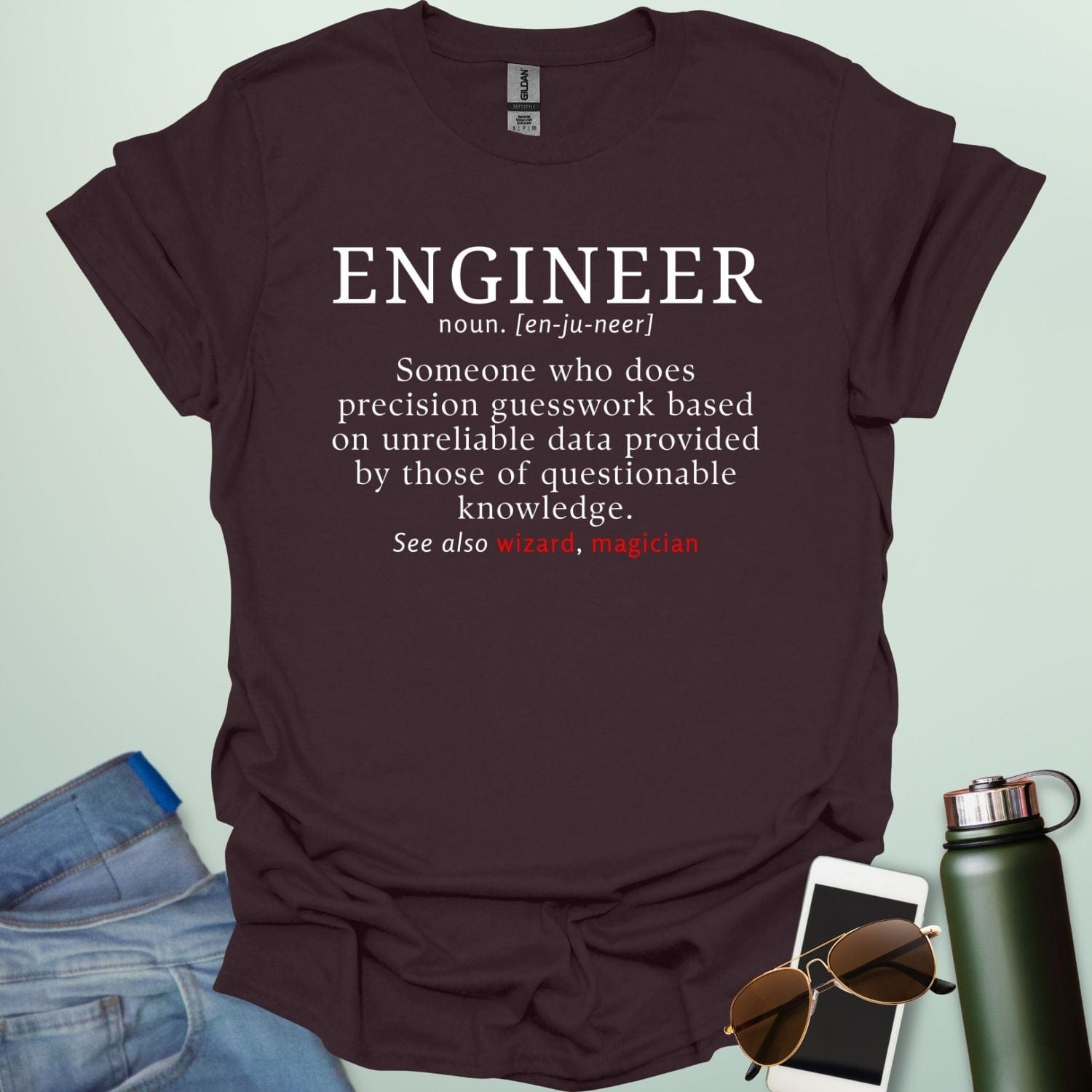 Engineer' t-shirt with a humorous dictionary-style definition and 'See also wizard, magician' in red.