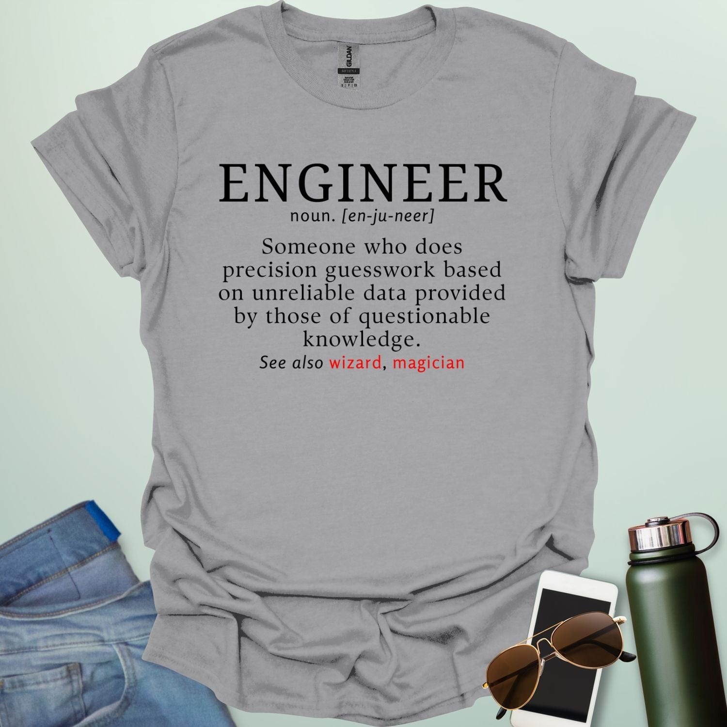 Engineer' t-shirt with a humorous dictionary-style definition and 'See also wizard, magician' in red.