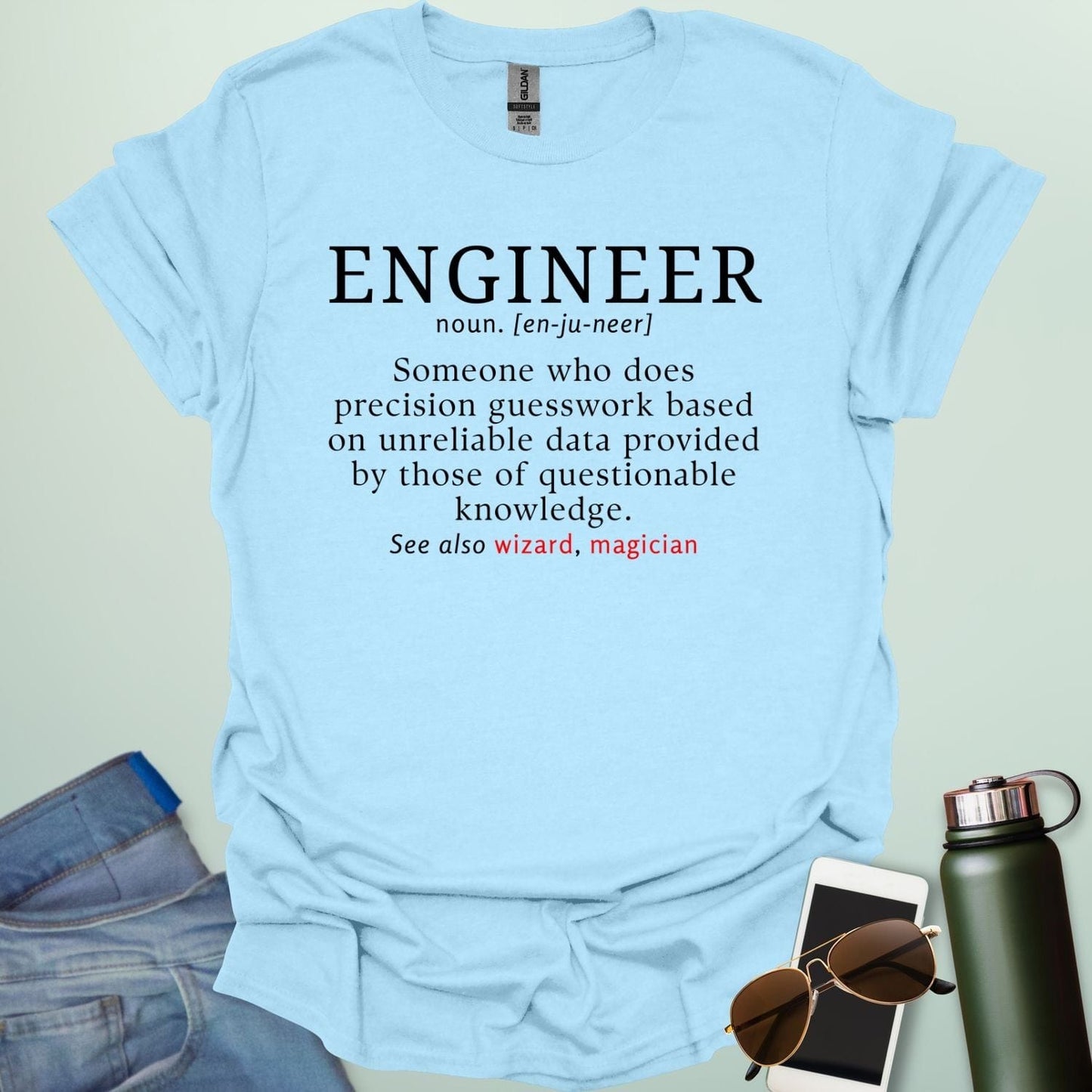 Engineer' t-shirt with a humorous dictionary-style definition and 'See also wizard, magician' in red.