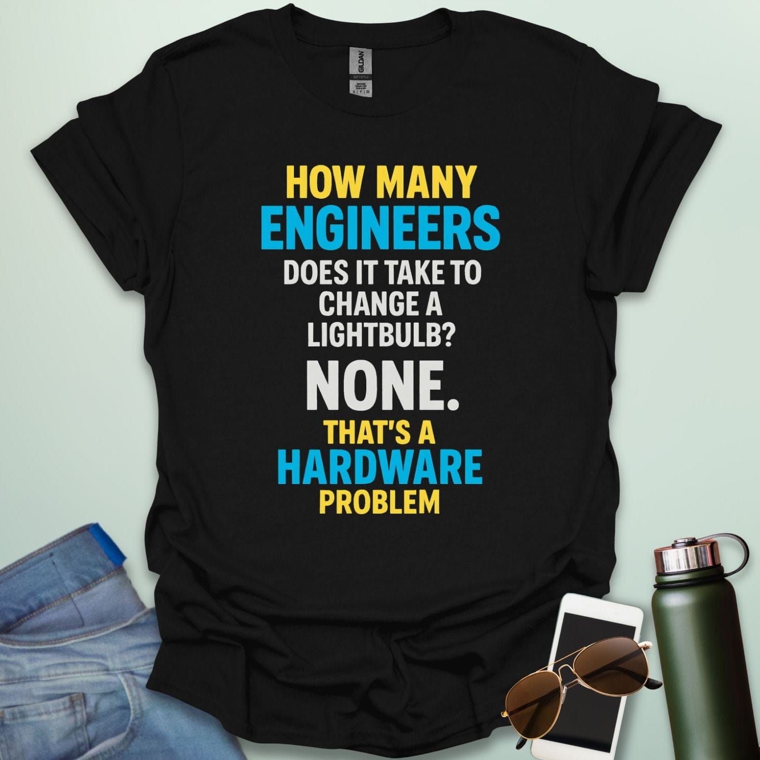 A black t-shirt with the engineering joke: 'How many engineers does it take to change a lightbulb? NONE. That's a hardware problem.