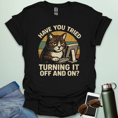 Funny 'Have You Tried Turning It Off and On' t-shirt with a retro-style cat at a computer.