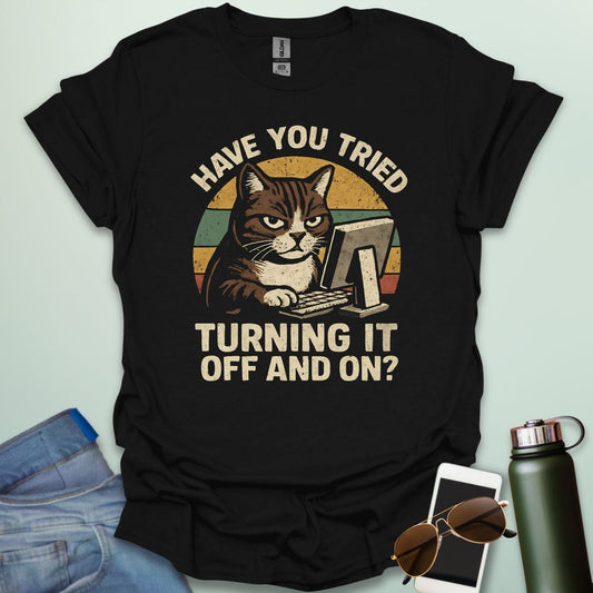 Funny 'Have You Tried Turning It Off and On' t-shirt with a retro-style cat at a computer.
